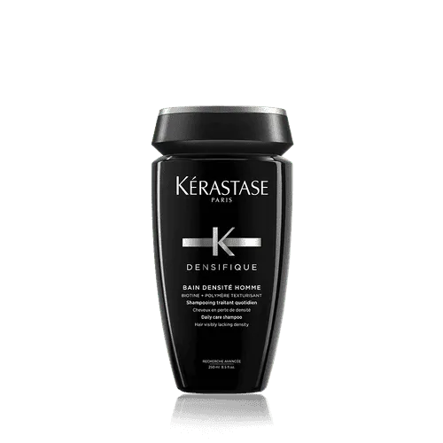 A sleek, black bottle of Densifique Bain Densité Homme 250ml shampoo by Kerestase features bold white text in a minimalist design that highlights the brand and product details. It's perfect for men aiming for denser hair and those who prioritize both style and function in their grooming routine.