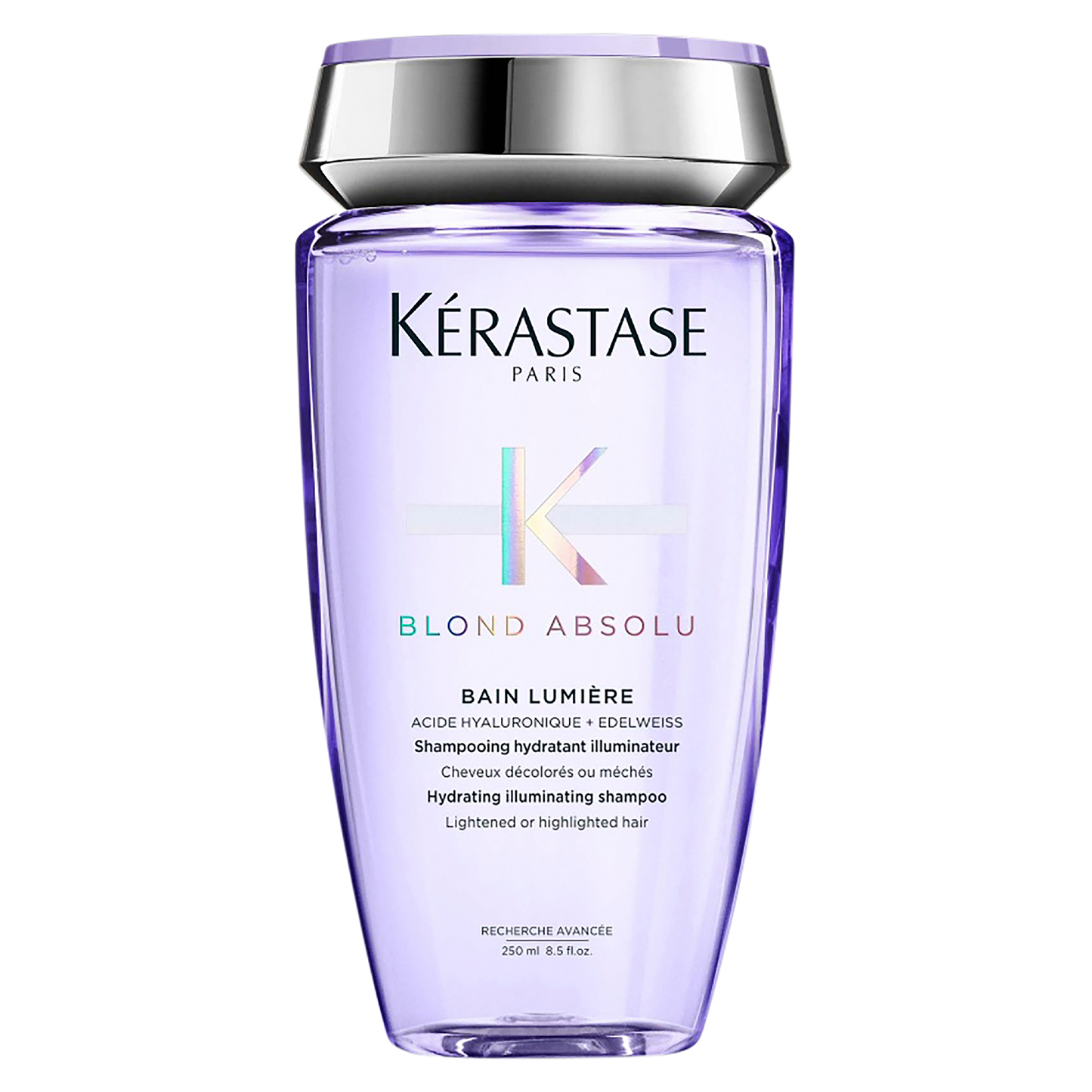 A lavender bottle of Blond Absolu Bain Lumiére 250ml by Kerestase is an illuminating shampoo crafted to hydrate and illuminate blonde hair. Enriched with Hyaluronic Acid, it includes a silver cap and reflective label details, ideal for enhancing lightened or highlighted locks.