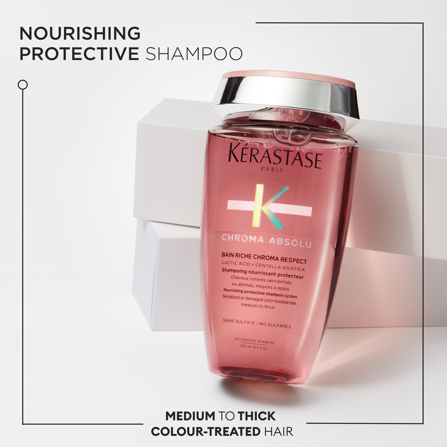 The Chroma Absolu Bain Riche Chroma Respect 250ml by Kérastase is ideal for medium to thick color-treated hair. Its pink bottle, adorned with a silver cap, complements the sleek white packaging. The text underscores its nourishing and protective properties, making it a must-have for your hair care routine.