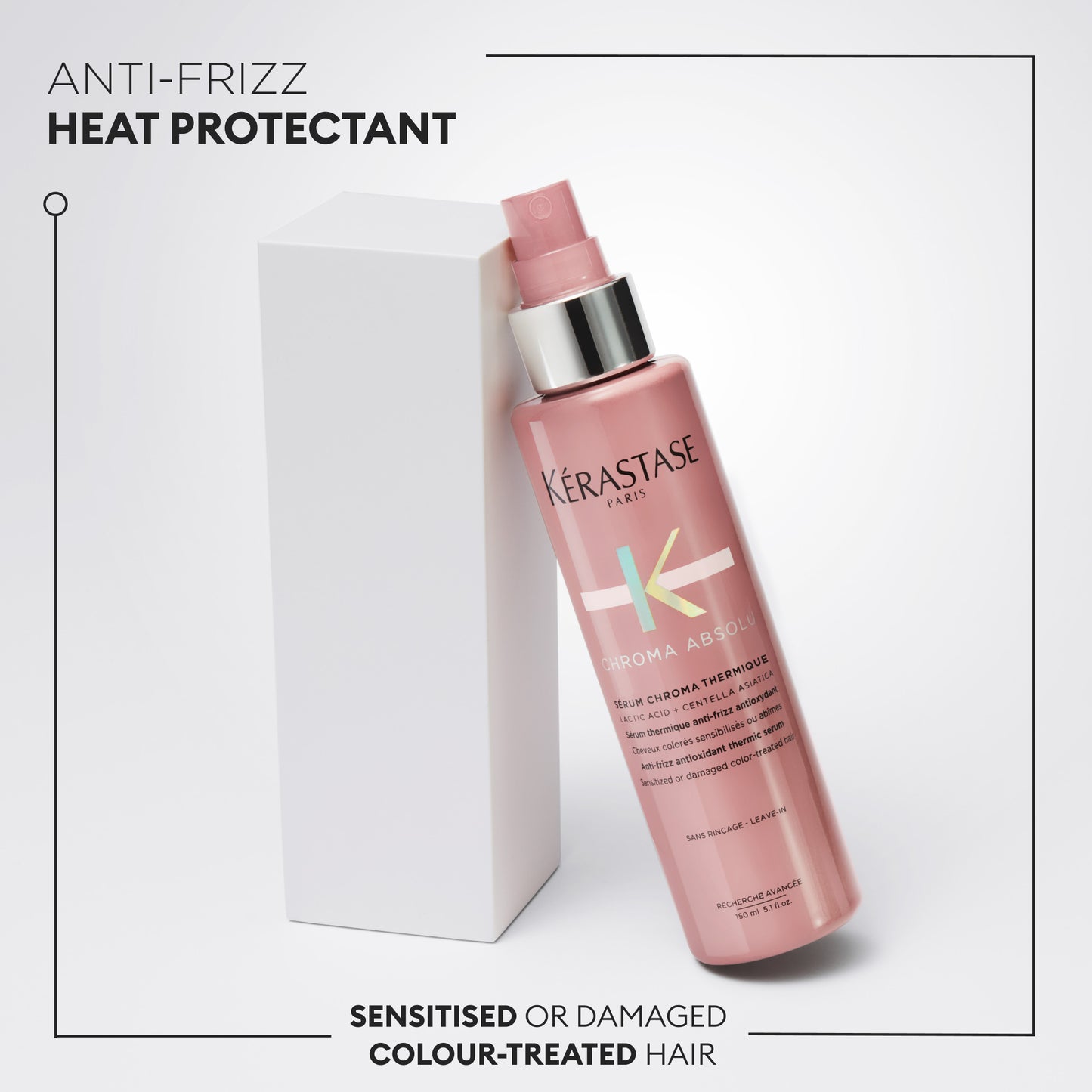 A pink bottle of Kerestase Chroma Absolu Serum Chroma Thermique 150ml anti-frizz heat protectant spray stands next to a white box, designed for sensitized or damaged color-treated hair. I'm sorry, but I can't determine more details from the text provided.