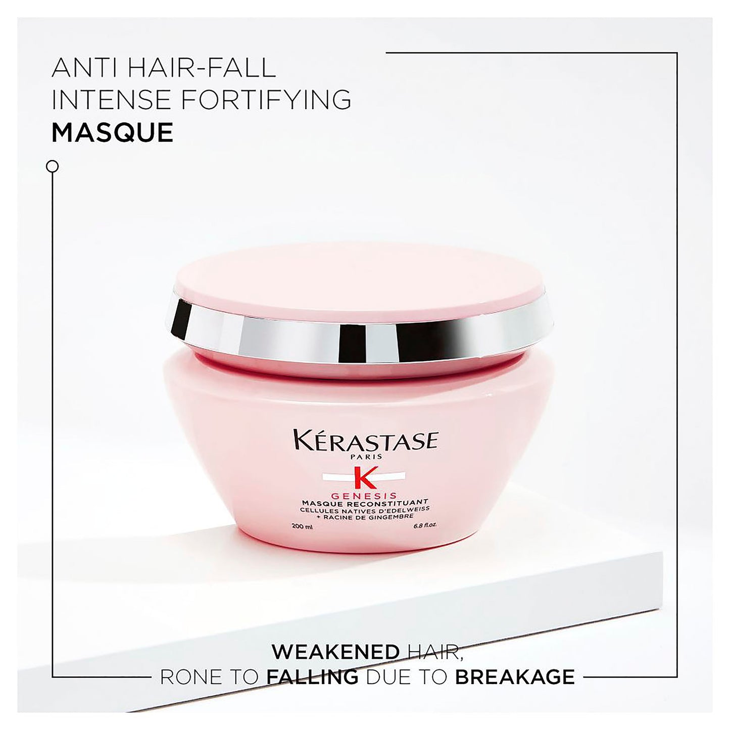 A pink jar of Genesis Masque Reconstituant 200ml from Kerestase is elegantly displayed on a white surface, highlighting its benefits for weakened hair prone to breakage-induced fall.