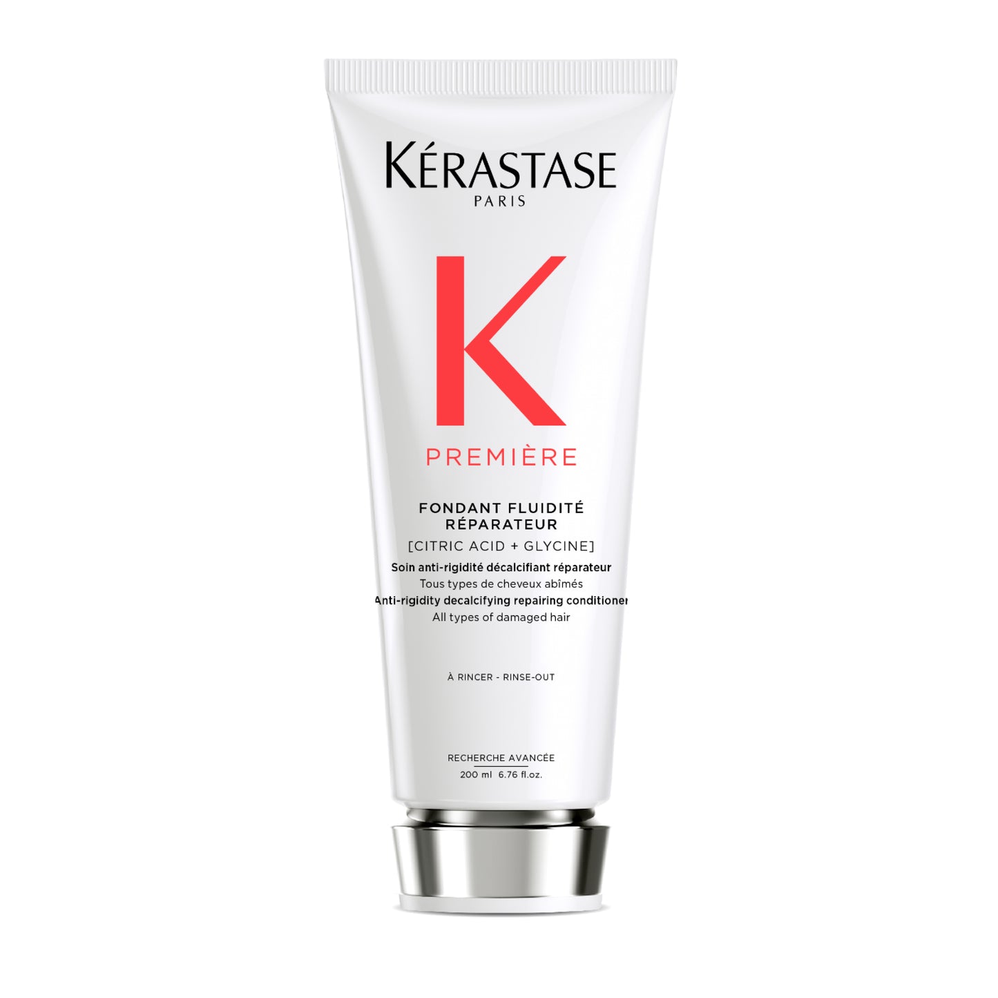 A white tube of Mooi Hair Première Fondant Fluidité Réparateur conditioner prominently displays a bold red "K" on the front. This innovative, decalcifying conditioner is formulated to repair and condition all types of damaged hair using citric acid and glycine. The tube has a capacity of 200 ml.
