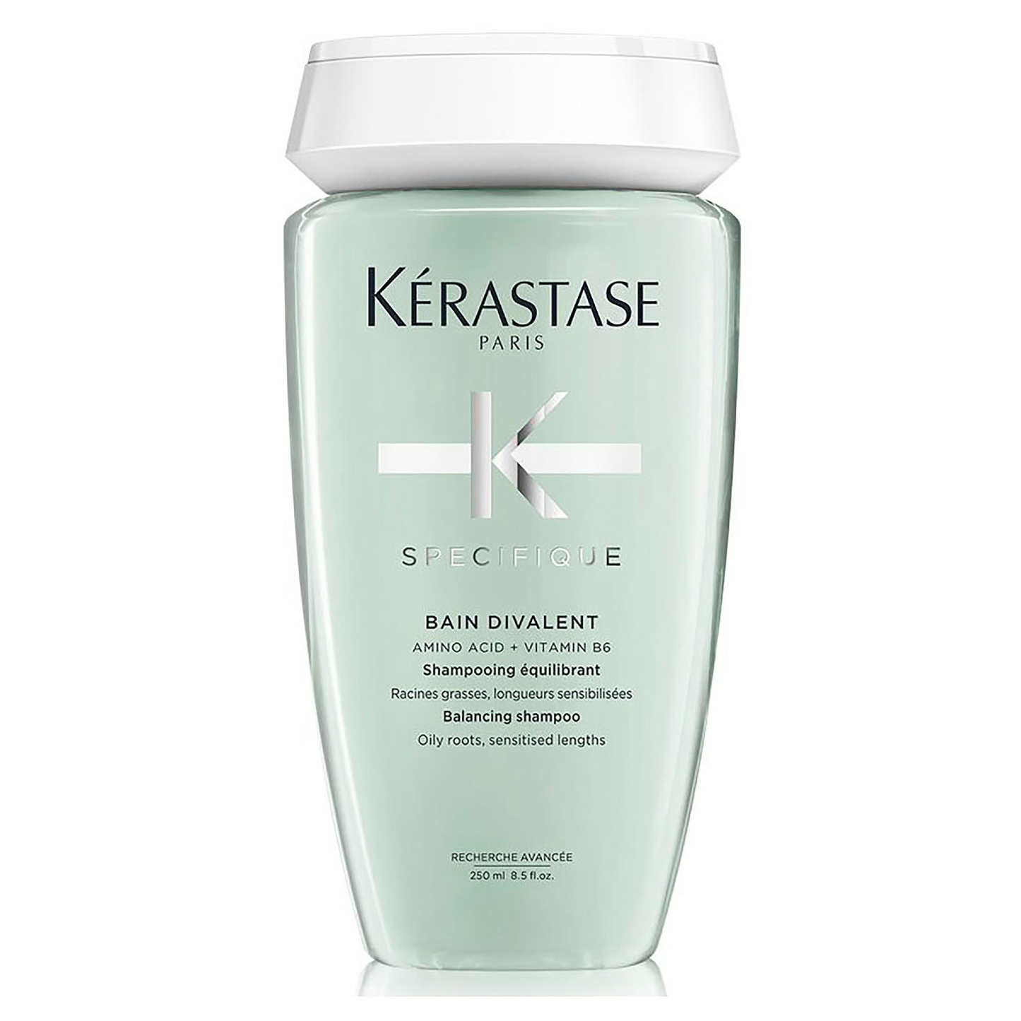 A 250ml bottle of Kerestase Specifique Bain Divalent shampoo includes amino acid and vitamin B6, perfectly formulated to balance oily roots and sensitized lengths. This stylish light green bottle with a white cap ensures complete care without feeling incomplete.