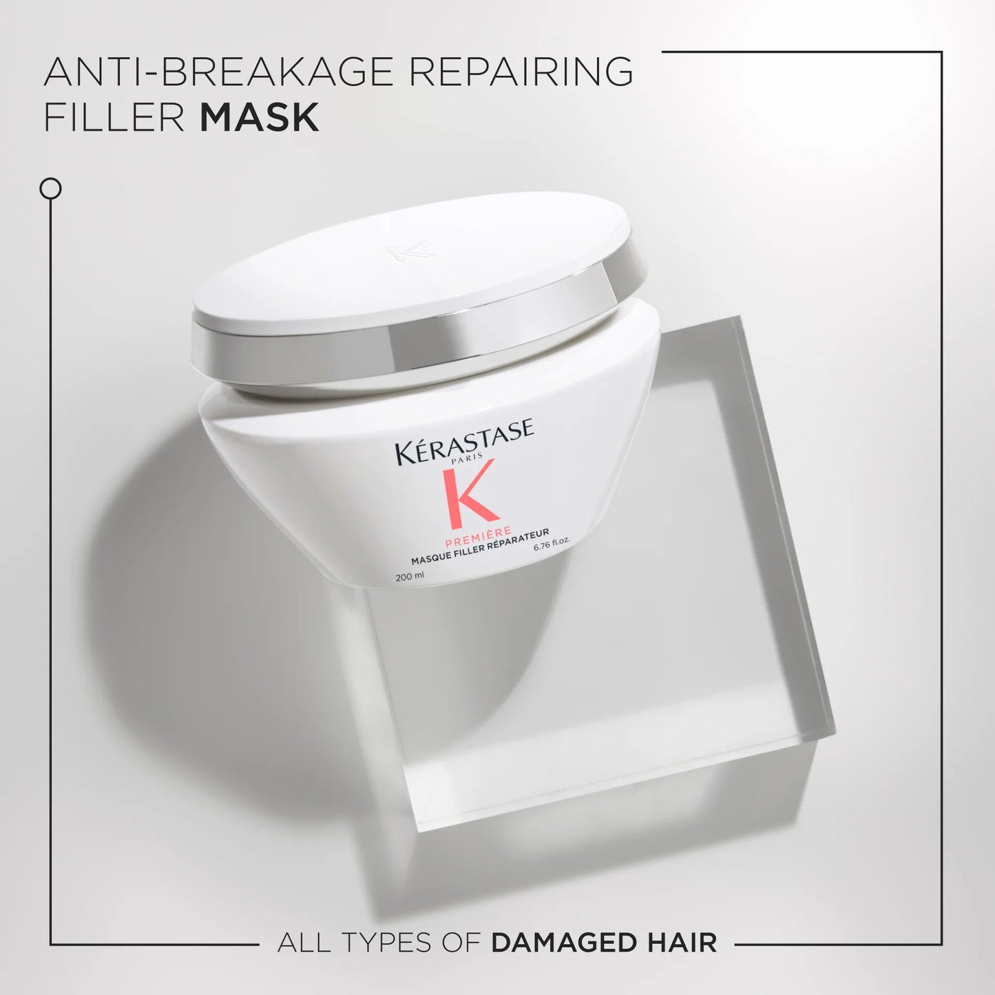 A white jar of Kerestase's Première Masque Filler Réparateur 200ml is displayed against a light gray background, highlighting its universal allure for all types of damaged hair.