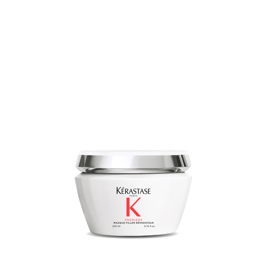 A white jar of Mooi Hair's Première Masque Filler Réparateur promises a transformative hair experience. The label emphasizes "Mooi Hair" in bold black and "Première Masque Filler Réparateur" in striking red, highlighting its reparative formula. With a volume of 200 ml, the metallic sheen lid adds an elegant touch.